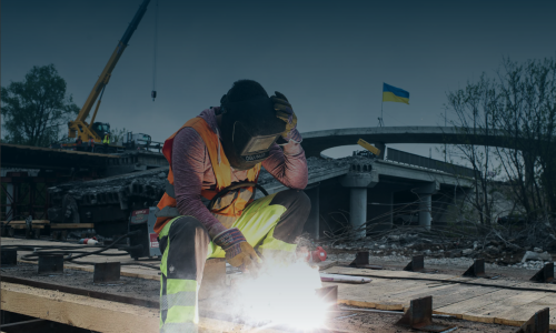 A welder works on a construction site of a highway in Ukraine
